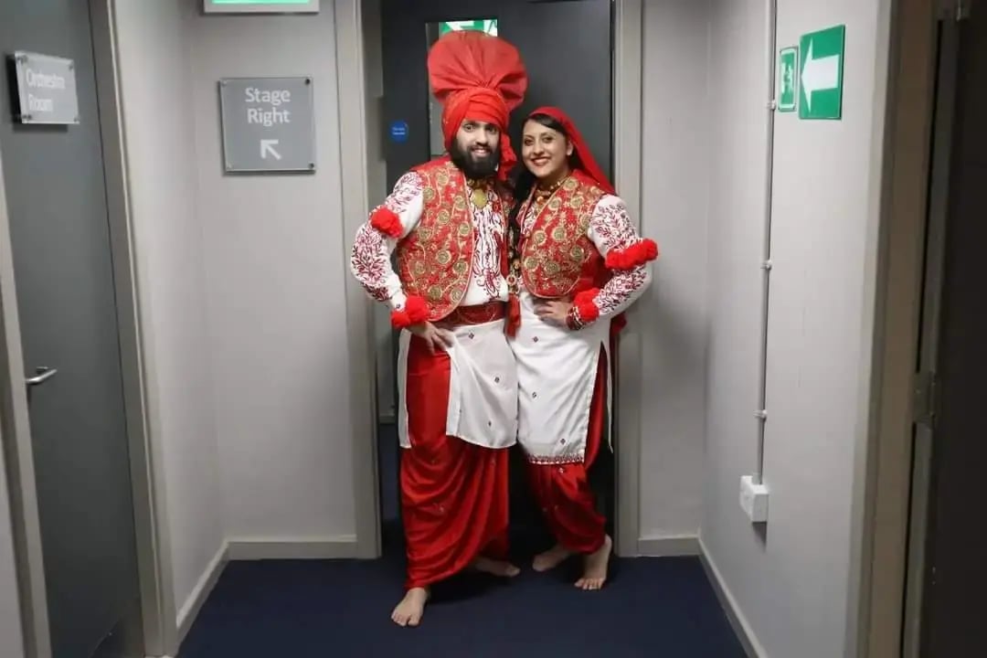 bhangra-dancers-in-traditional-red-and-white-costumes